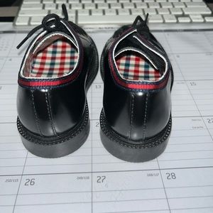 Toddler black Gucci dress shoes.